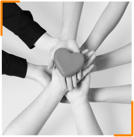 Multiple hands holding a heart-shaped object, symbolizing teamwork and unity.